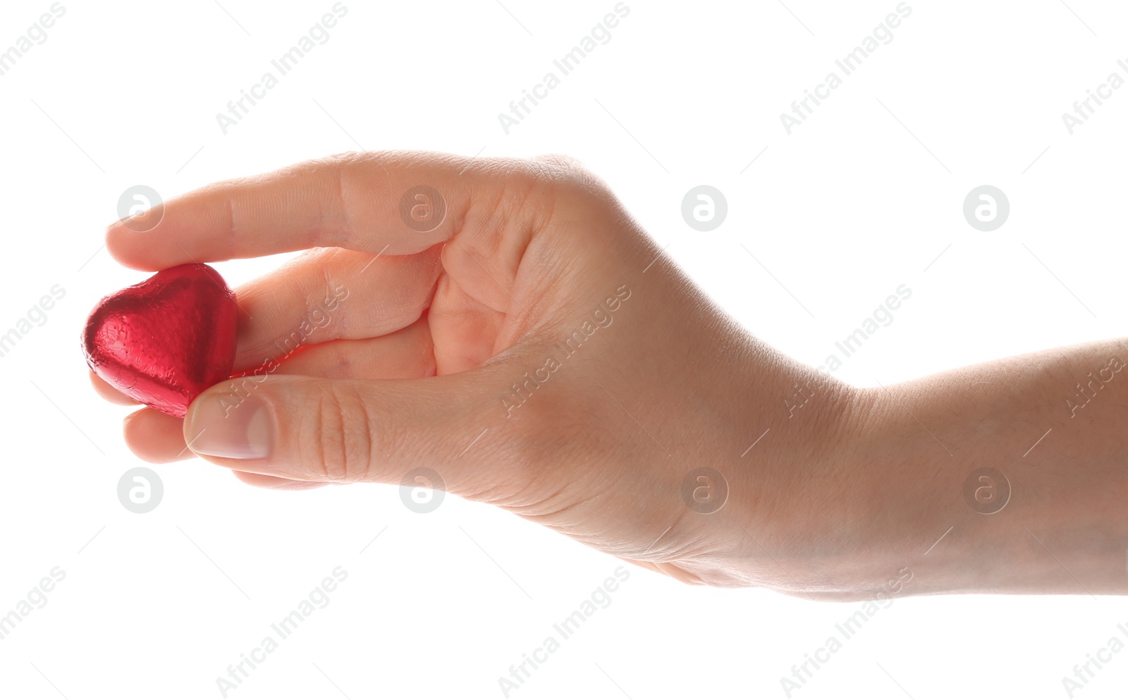 Photo of Woman holding heart shaped chocolate candy on white background, closeup