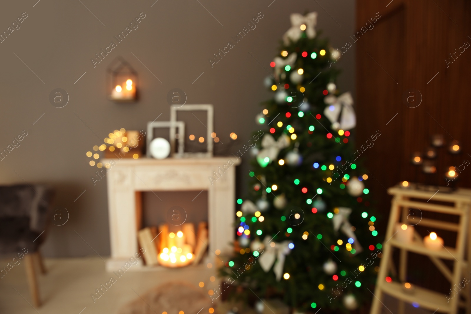 Photo of Blurred stylish room interior with Christmas tree and decorative fireplace