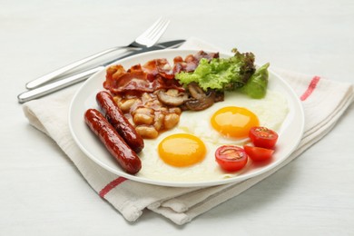 Delicious breakfast with sunny side up eggs served on white table