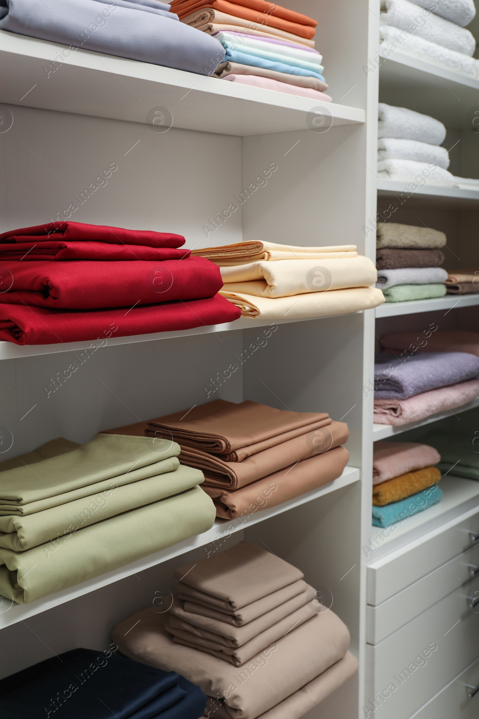 Photo of Different colorful bed linens on display in home textiles store