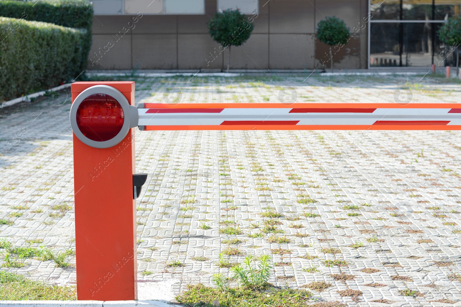 Photo of Closed boom barrier on sunny day outdoors