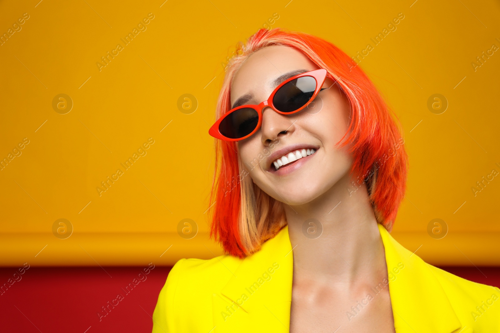 Photo of Beautiful young woman with bright dyed hair on color background, space for text