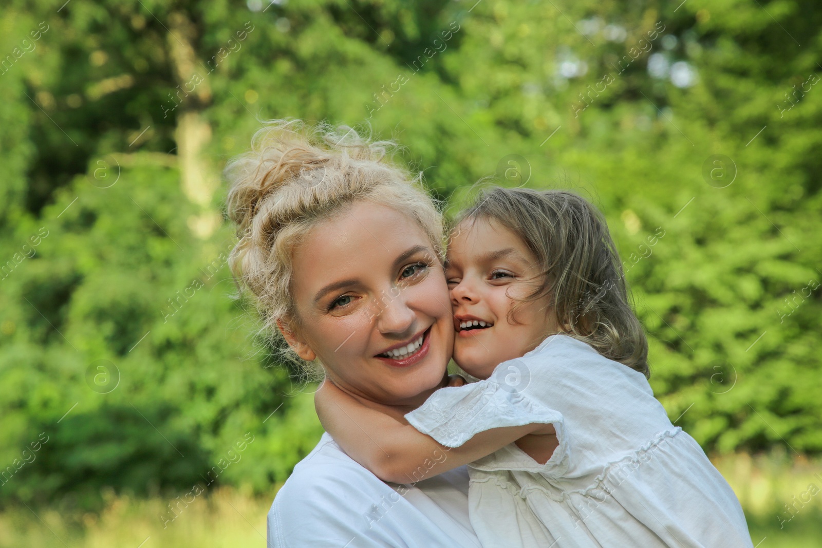 Photo of Portrait of happy mother with her cute daughter outdoors