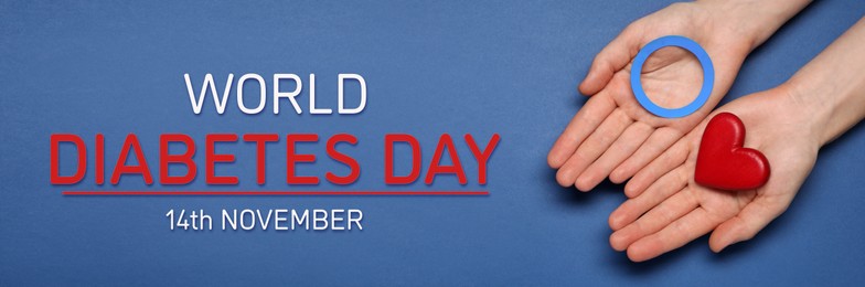 Image of World Diabetes Day. Woman holding light blue paper circle and decorative red heart on color background, top view. Banner design