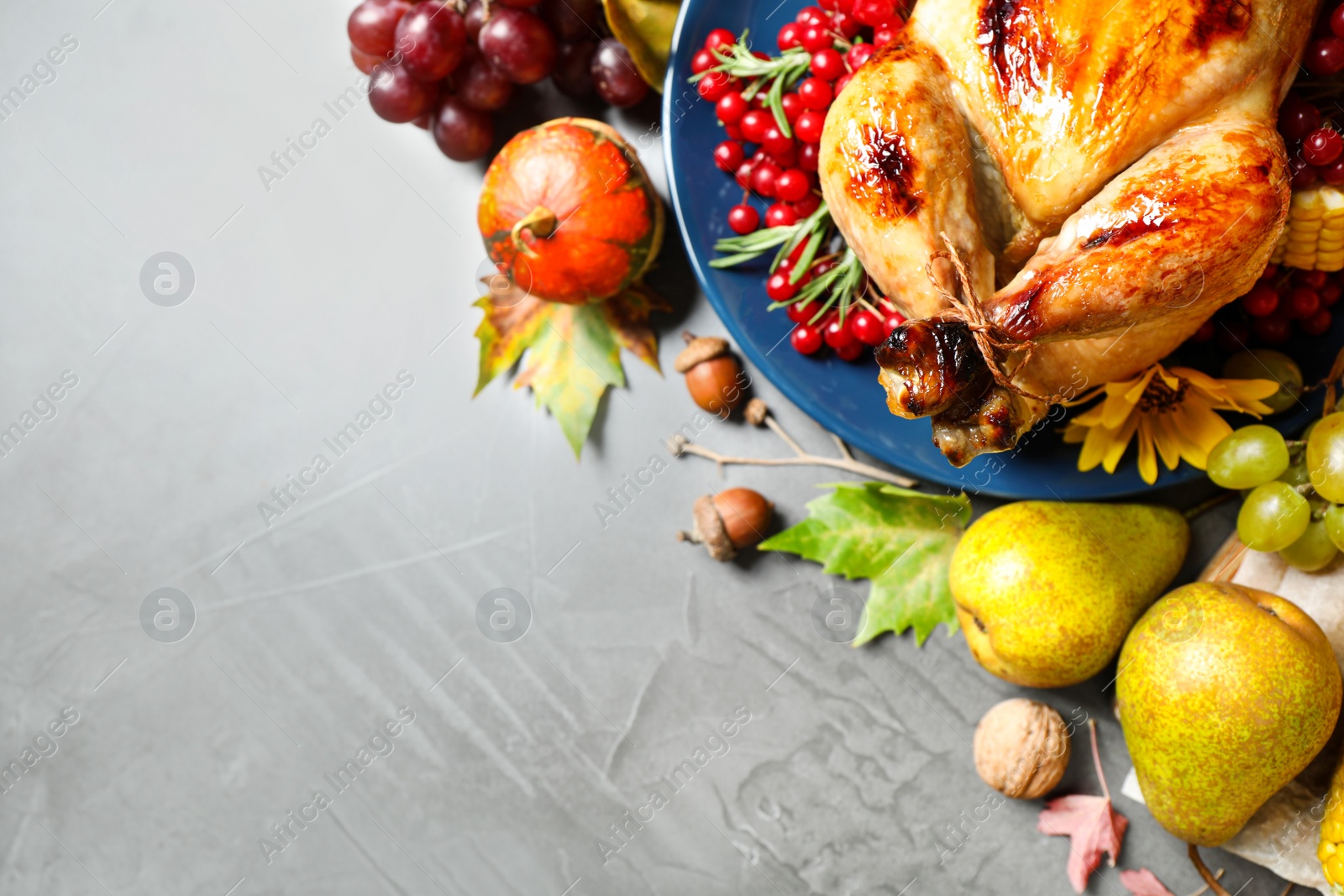 Photo of Flat lay composition with delicious turkey on grey background, space for text. Happy Thanksgiving day