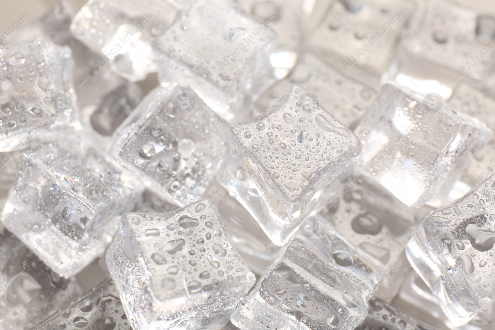 Photo of Melting ice cubes with water drops as background, closeup