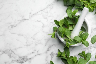 Flat lay composition with fresh green mint and space for text on marble background