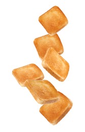 Slices of tasty toasted bread falling on white background