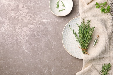 Flat lay composition with thyme, rosemary, mint and space for text on table