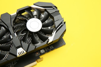 Photo of Computer graphics card on yellow background, above view. Space for text