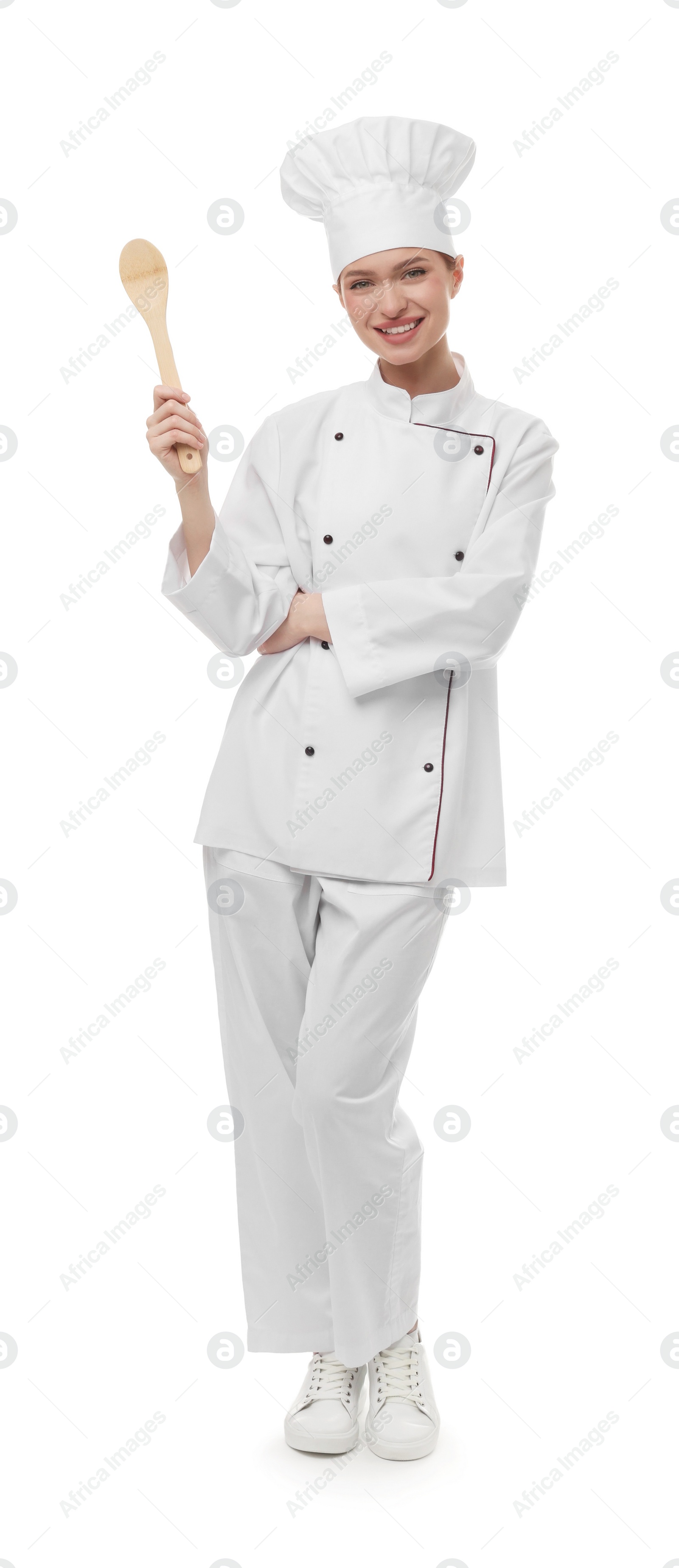 Photo of Happy chef in uniform holding wooden spoon on white background