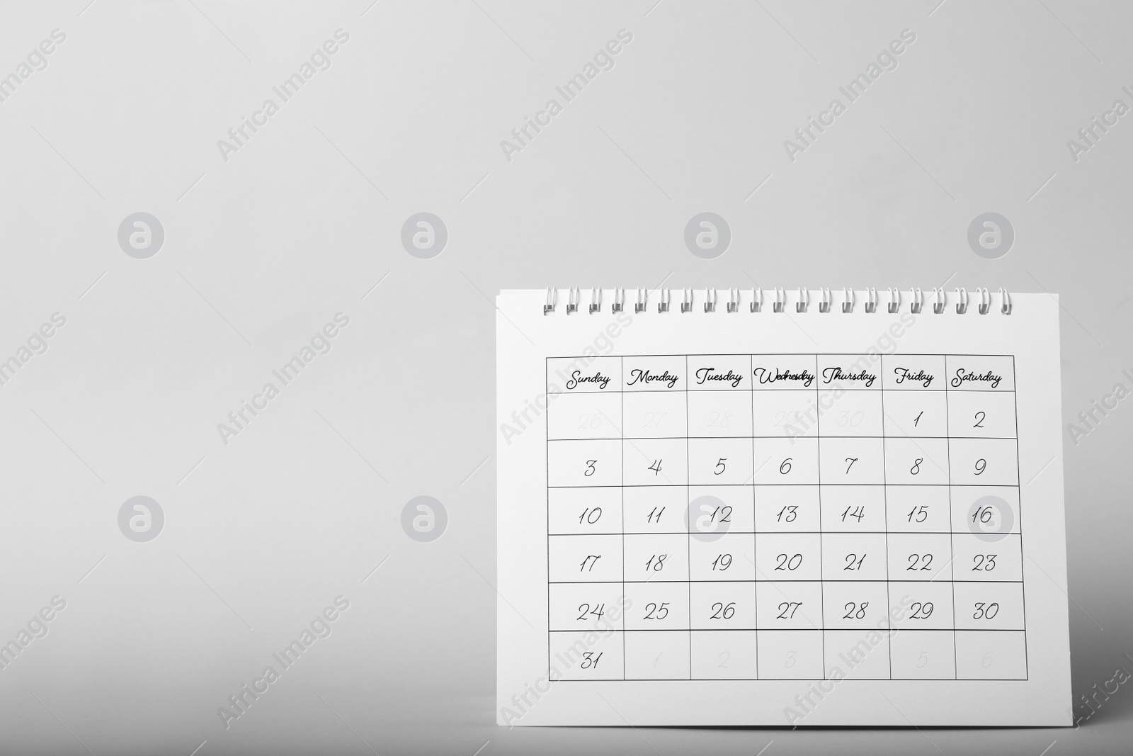 Photo of Paper calendar on grey background, space for text. Planning concept