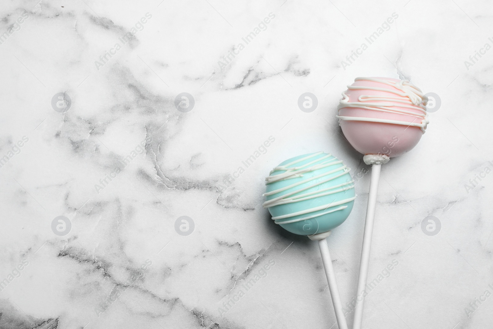 Photo of Sweet colorful cake pops on white background, flat lay. Space for text