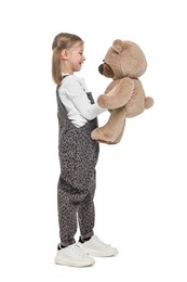 Photo of Cute girl with teddy bear on white background