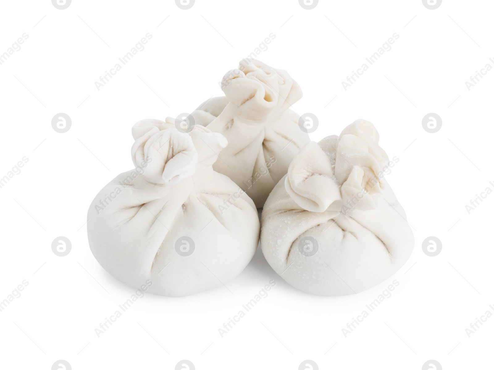 Photo of Uncooked khinkali (dumplings) isolated on white. Georgian cuisine