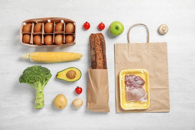 Photo of Fresh vegetables and other products on light grey background, flat lay