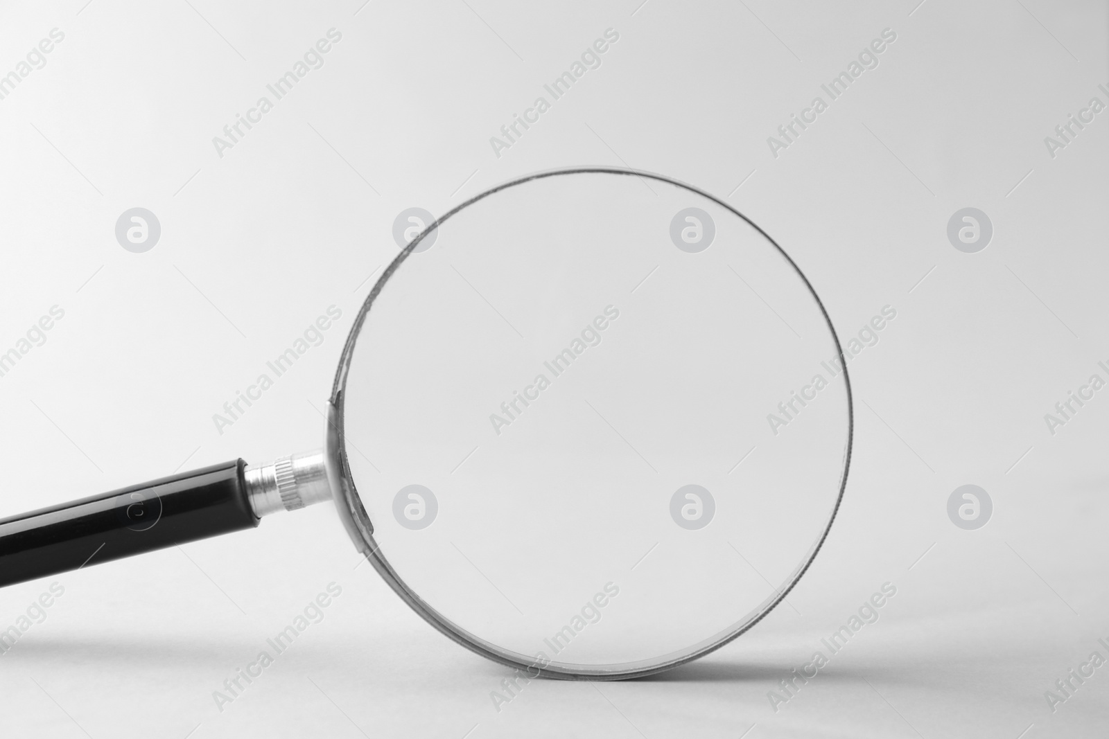 Photo of Magnifying glass with handle on white background