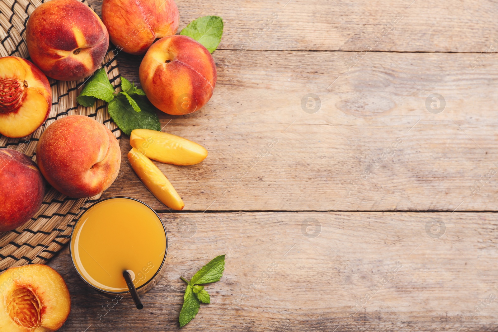 Photo of Natural peach juice and fresh fruits on wooden table, flat lay. Space for text