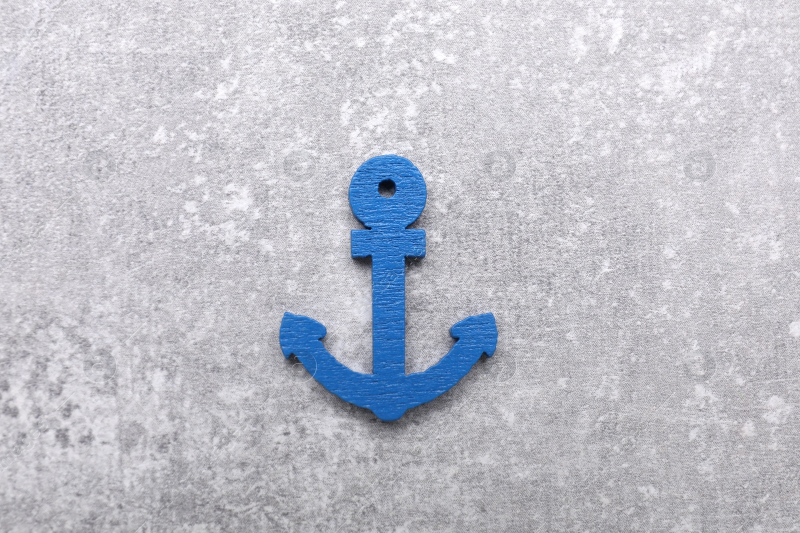 Photo of Anchor figure on light grey table, top view