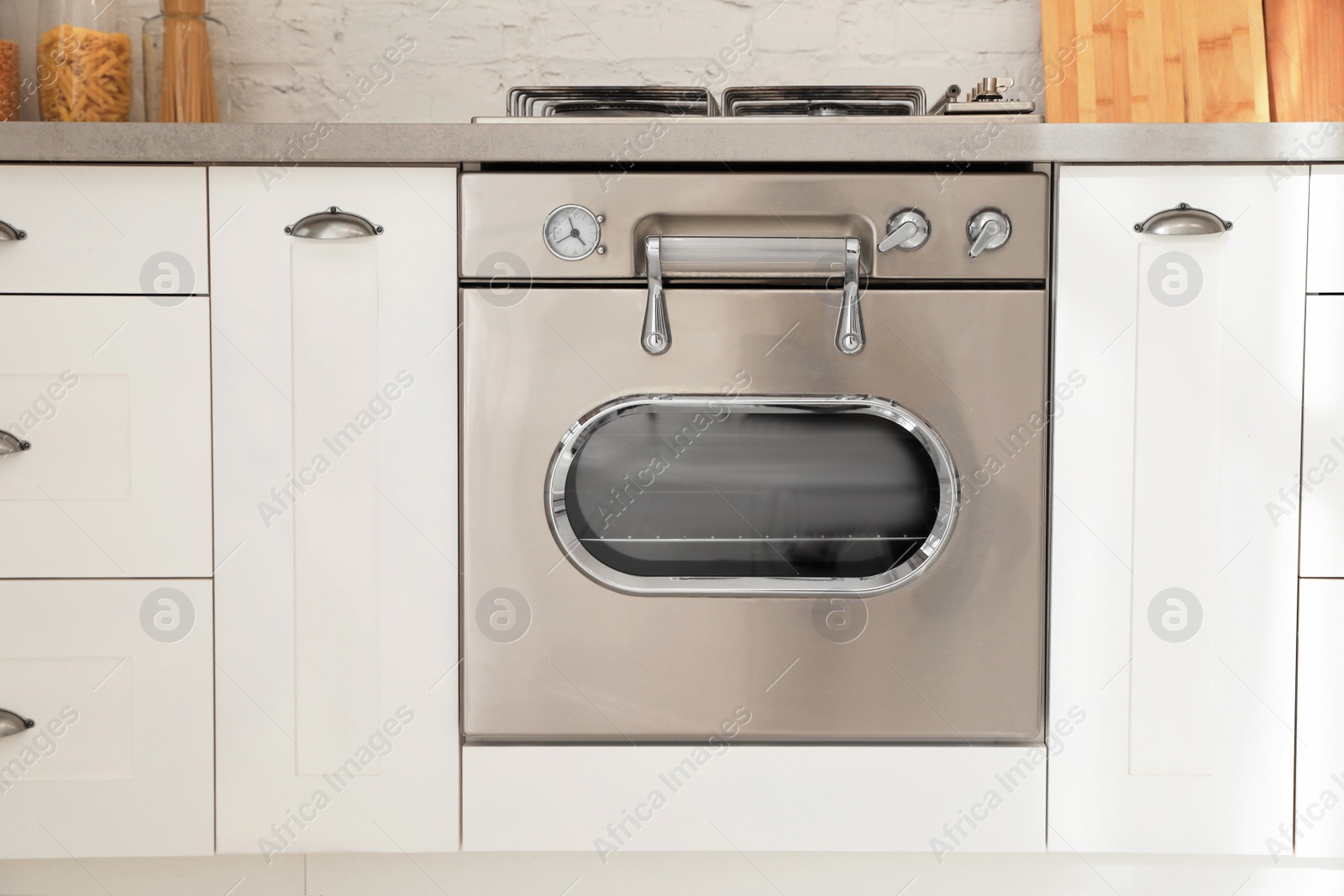 Photo of New modern oven in stylish kitchen. Cooking appliance