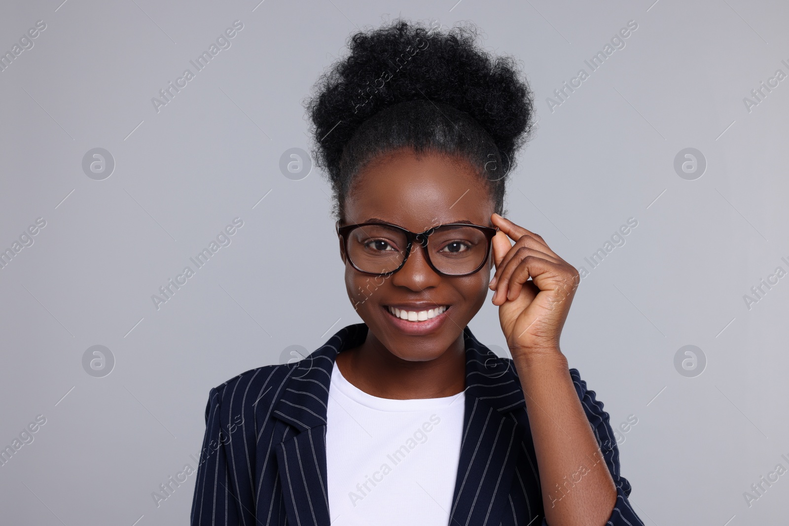 Photo of Portrait of beautiful young woman on light grey background