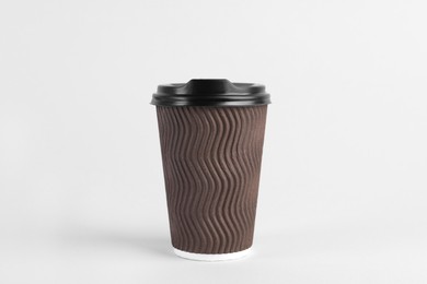 Photo of Brown paper cup with plastic lid on light background. Coffee to go