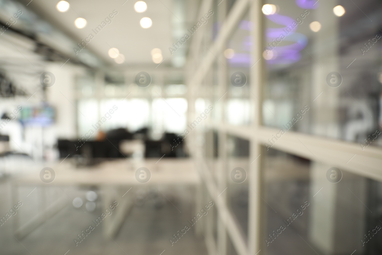 Photo of Blurred view of cozy workspaces with tables and chairs in office