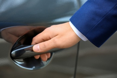 Closeup view of man opening car door