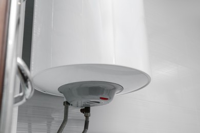 Photo of White boiler with maximum energy efficiency indicator indoors