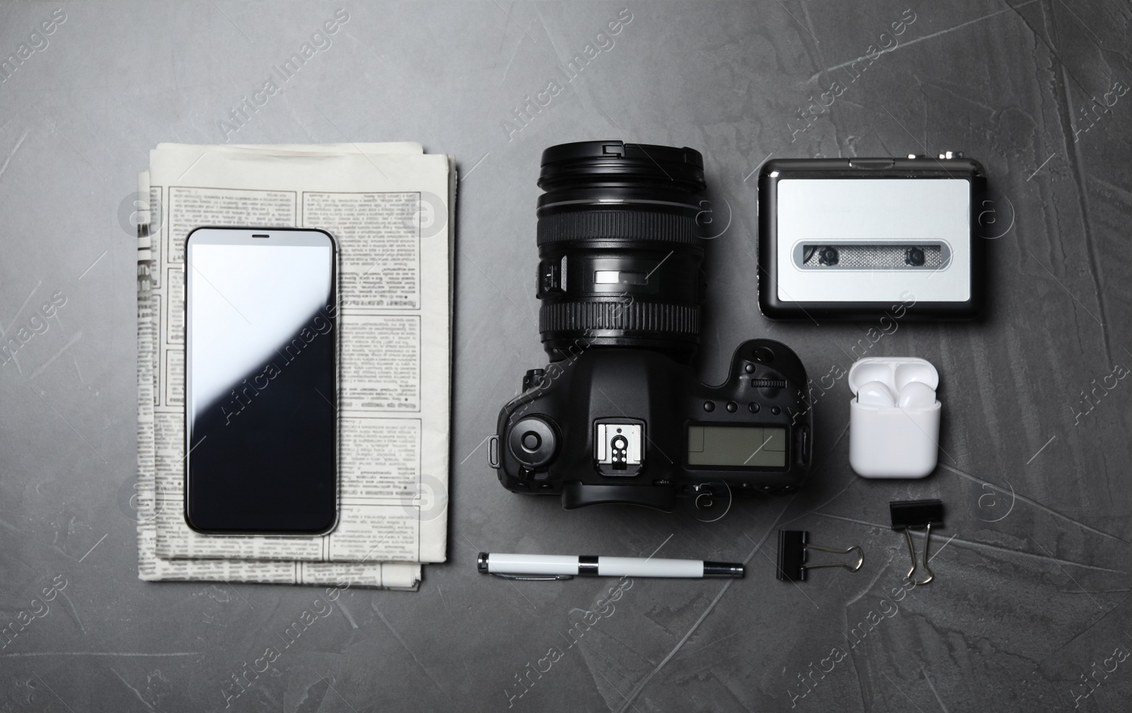 Photo of Flat lay composition with equipment for journalist on grey table