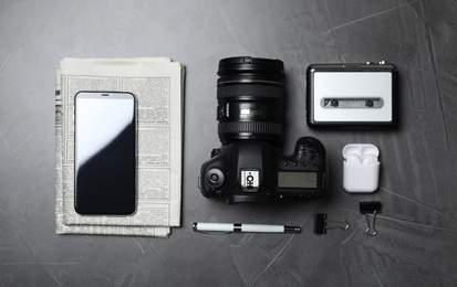 Flat lay composition with equipment for journalist on grey table