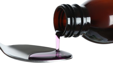 Pouring cough syrup into spoon on white background