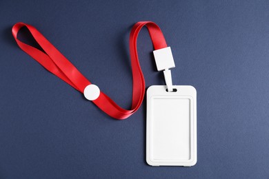 Photo of Blank badge with string on blue background, top view