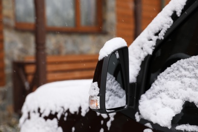 Car covered with snow after storm outdoors on beautiful winter day, closeup. Space for text