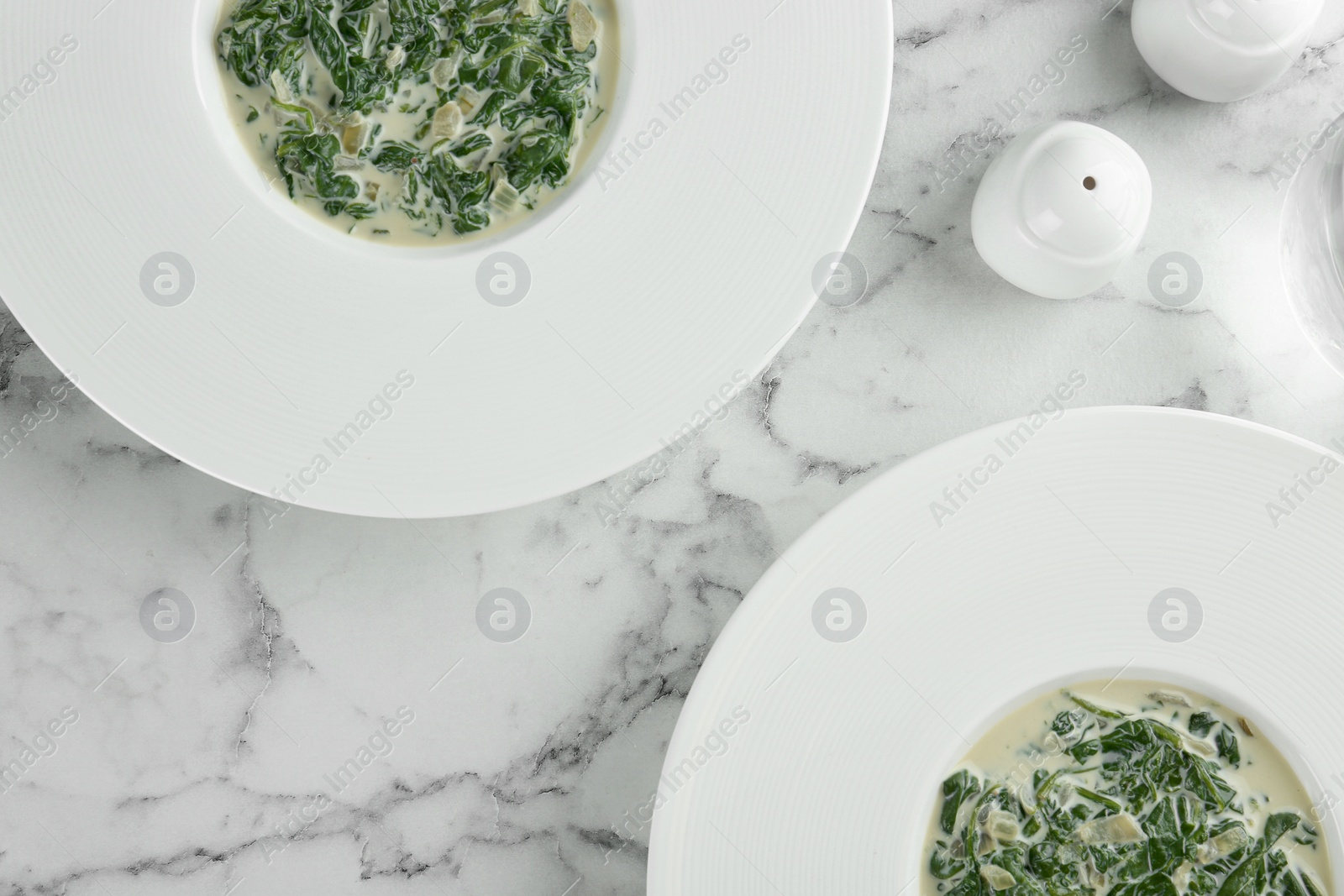 Photo of Tasty spinach dip on white marble table, flat lay