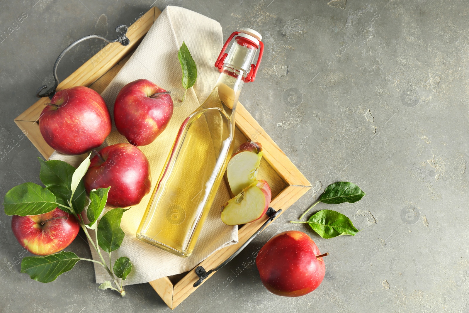 Photo of Flat lay composition with delicious apple cider on gray table, space for text