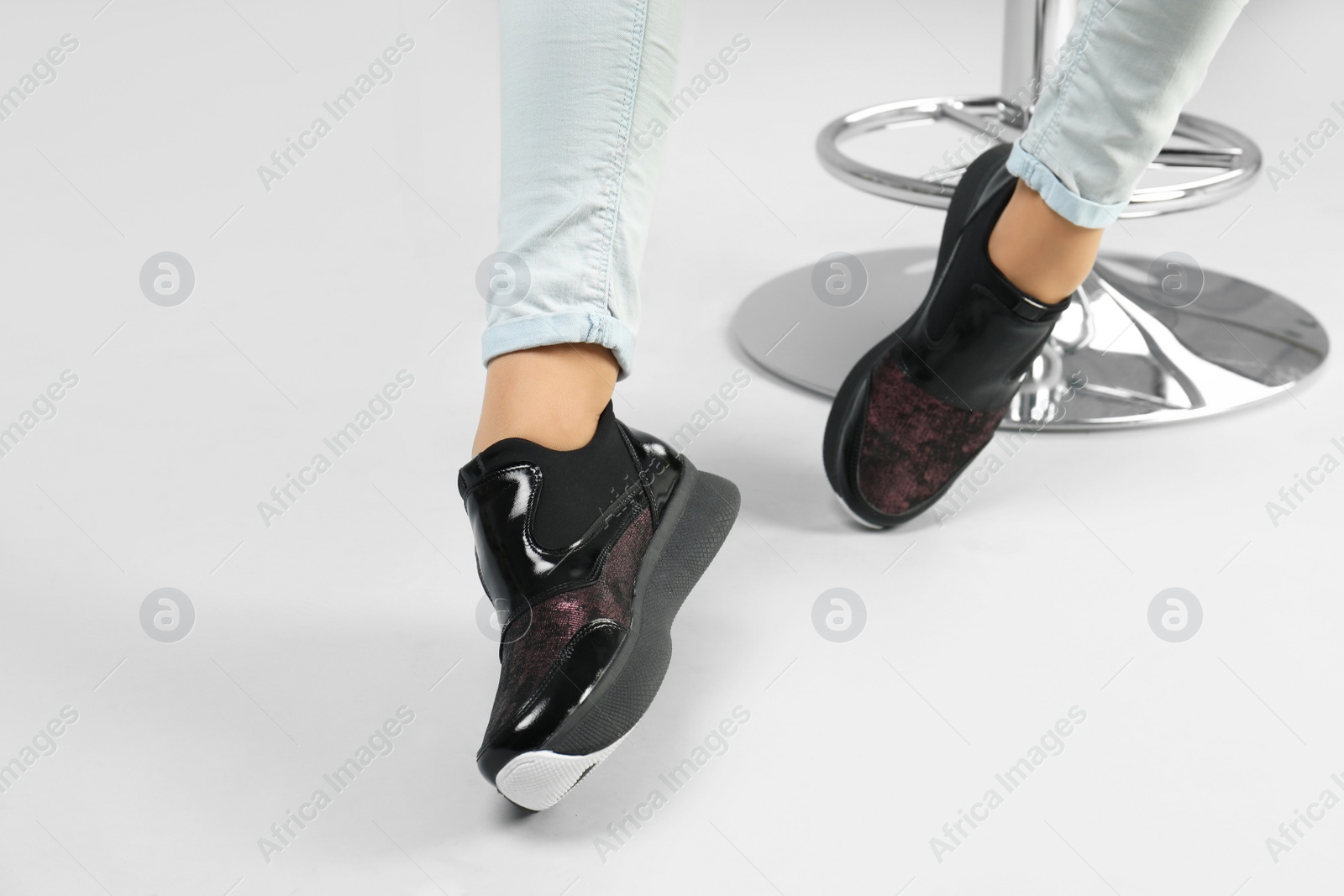 Photo of Woman in stylish shoes on grey background, closeup