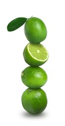 Image of Stacked whole and cut limes on white background