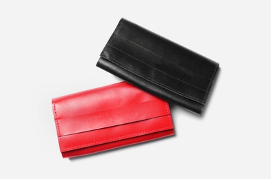 Stylish leather wallets on white background, top view