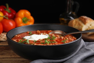 Bowl of delicious stuffed pepper soup on wooden table