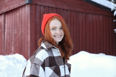 Photo of Portrait of beautiful young woman on snowy day outdoors. Winter vacation