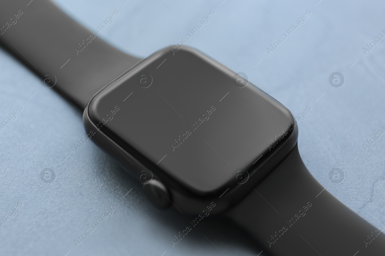 Stylish smart watch on grey stone table, closeup Photo of Stylish smart watch on grey stone table, closeup