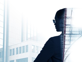 Double exposure of businesswoman and cityscape with office buildings and bridge