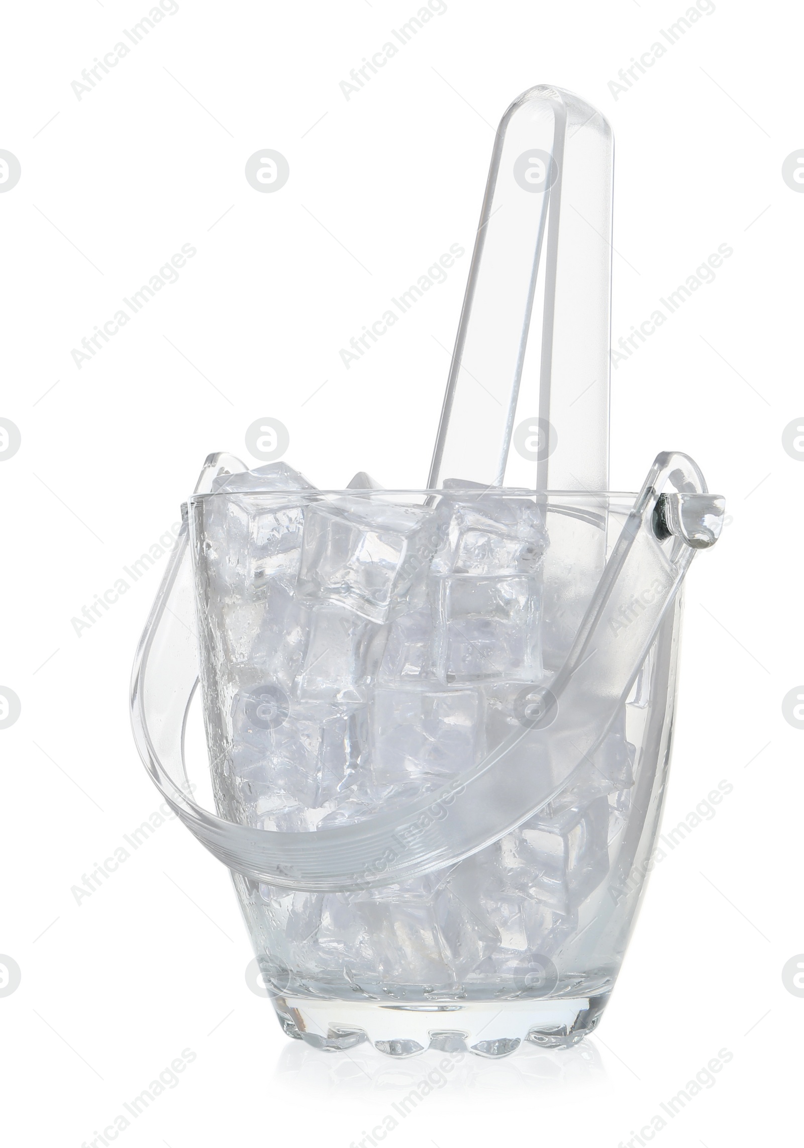 Photo of Glass bucket with ice cubes and tongs isolated on white