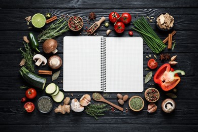Photo of Open recipe book and different ingredients on black wooden table, flat lay. Space for text
