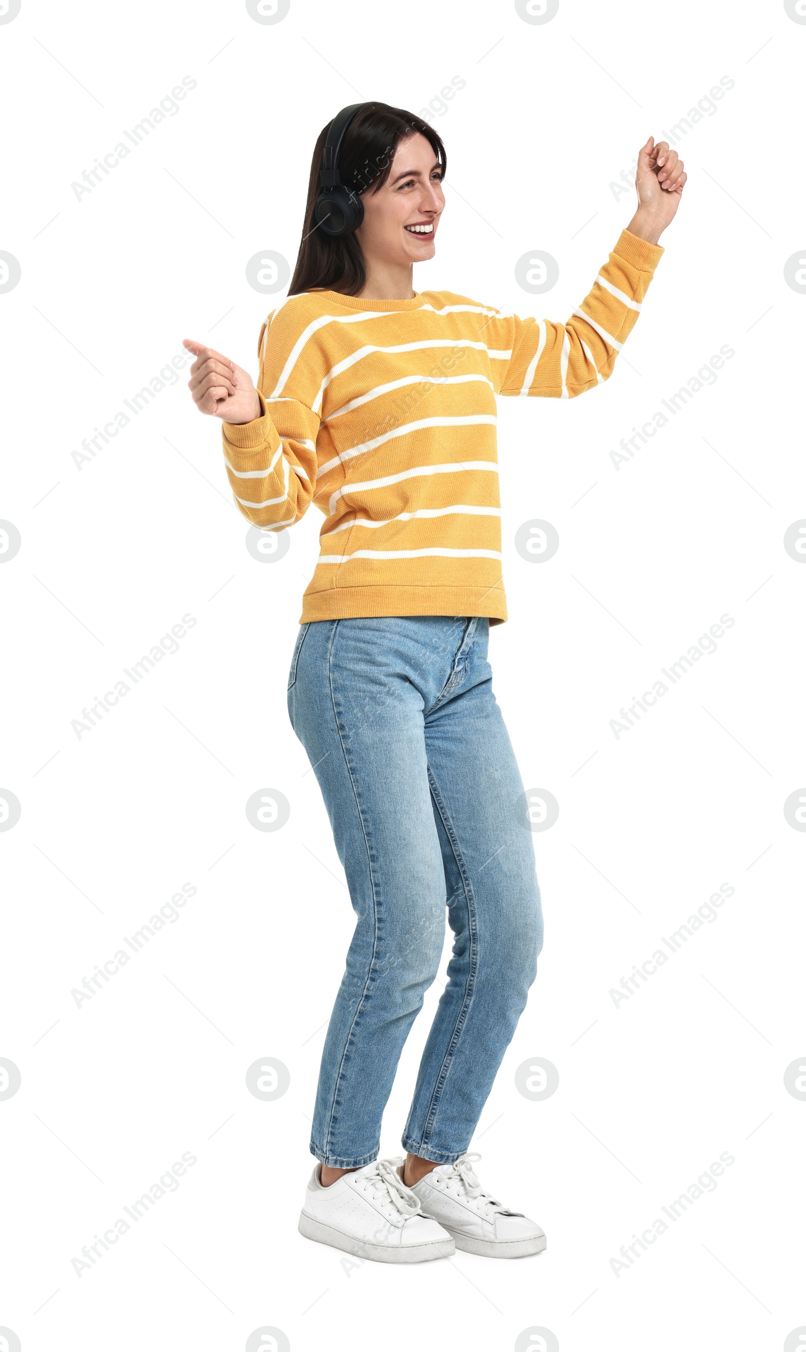 Photo of Happy woman with headphones dancing on white background