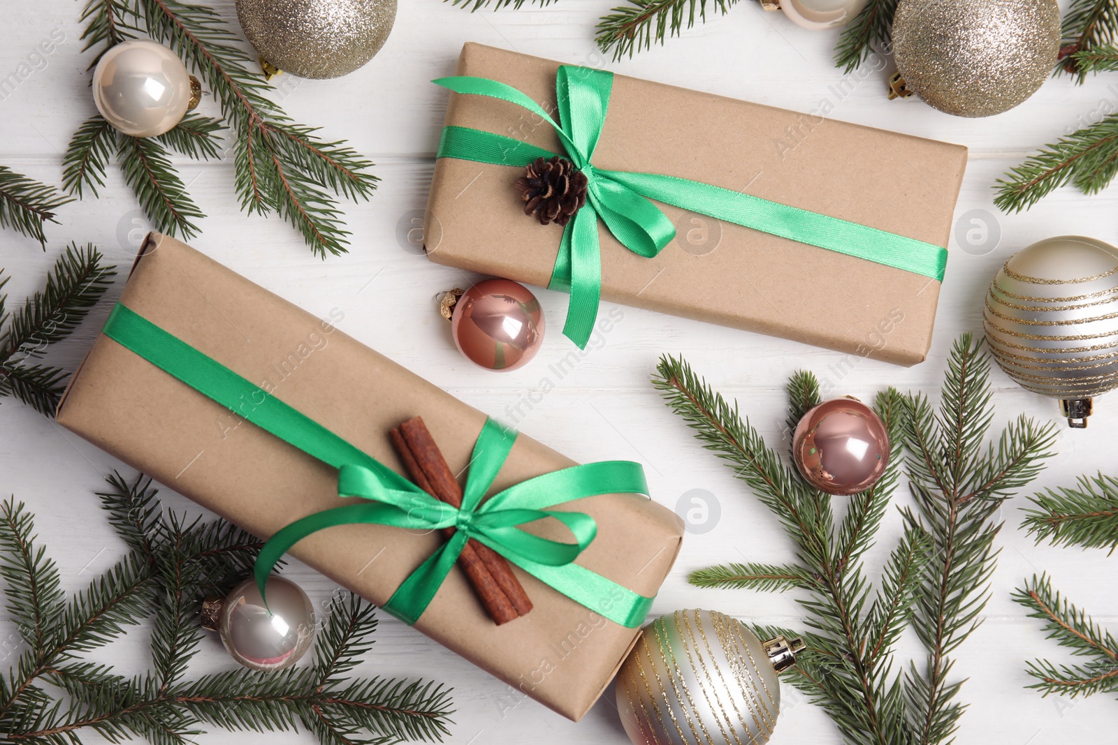 Photo of Flat lay composition with Christmas gift boxes on white wooden table