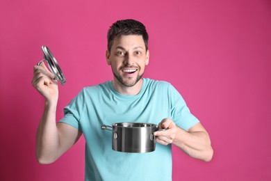Photo of Happy man with pot on pink background