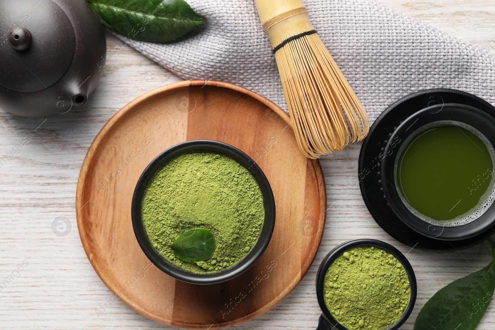 Photo of Flat lay composition with green matcha powder on white wooden table