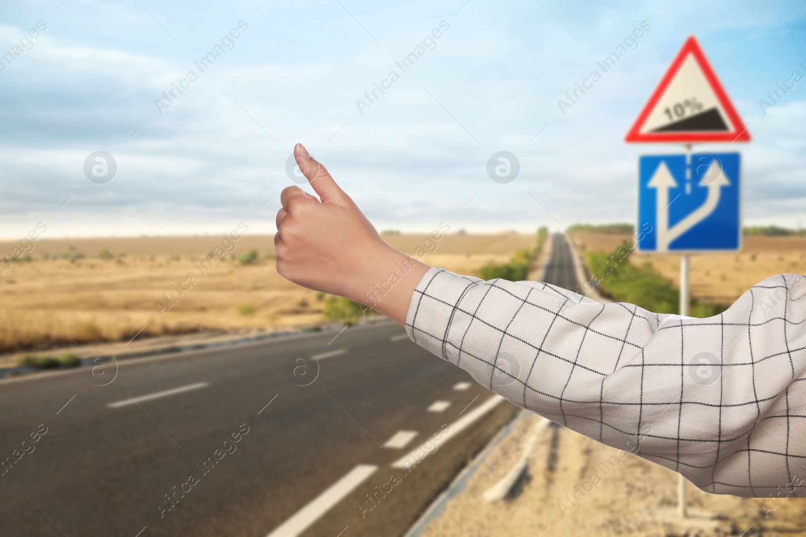 Image of Woman catching car on road, closeup. Hitchhiking trip